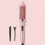 The pink Volara thermal brush glowing, with two black sectioning clips