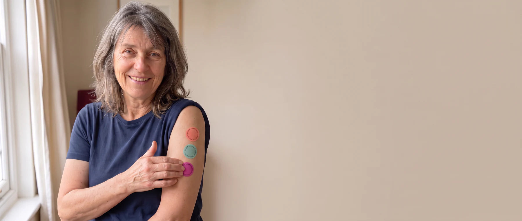 Woman showing three Renomi patches on her upper arm